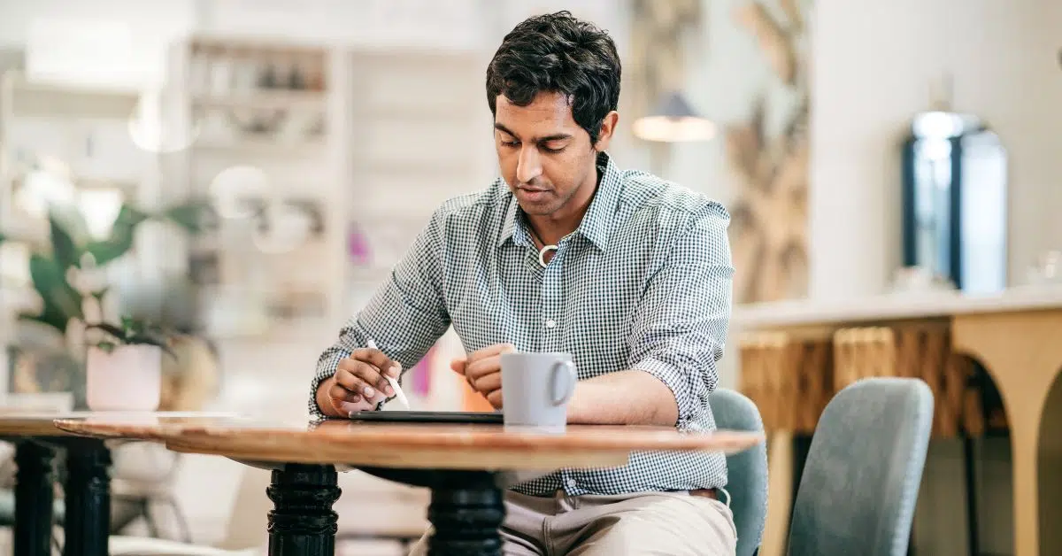 Remote Hybrid Worker with laptop in cafe